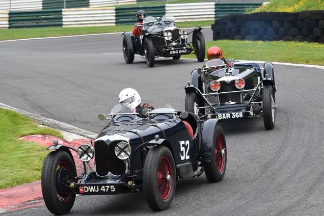 Old sports cars racing at the Vintage Motorsport Festival at Cadwell Park